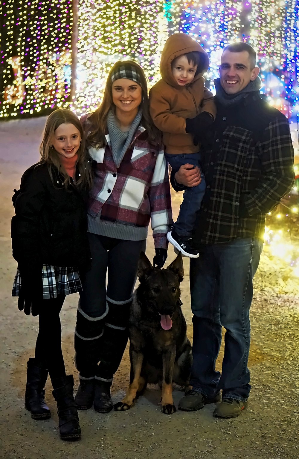 The Norbeck family with their German Shepherd at a holiday light display